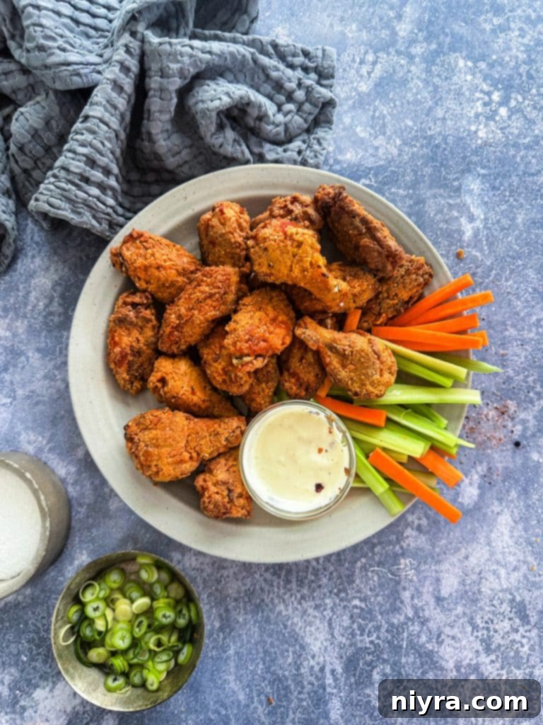 Crispy Hooters Style Air Fryer Wings 2 Crispy Air Fryer Copycat Hooters Wings on a plate with celery and blue cheese