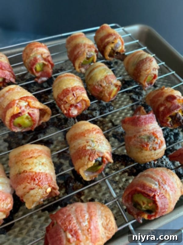 Bacon Wrapped Hot Brussels Sprouts prepared on a cookie sheet in the oven