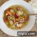 Overhead of Polish Sauerkraut Soup - Kapusniak in a white bowl