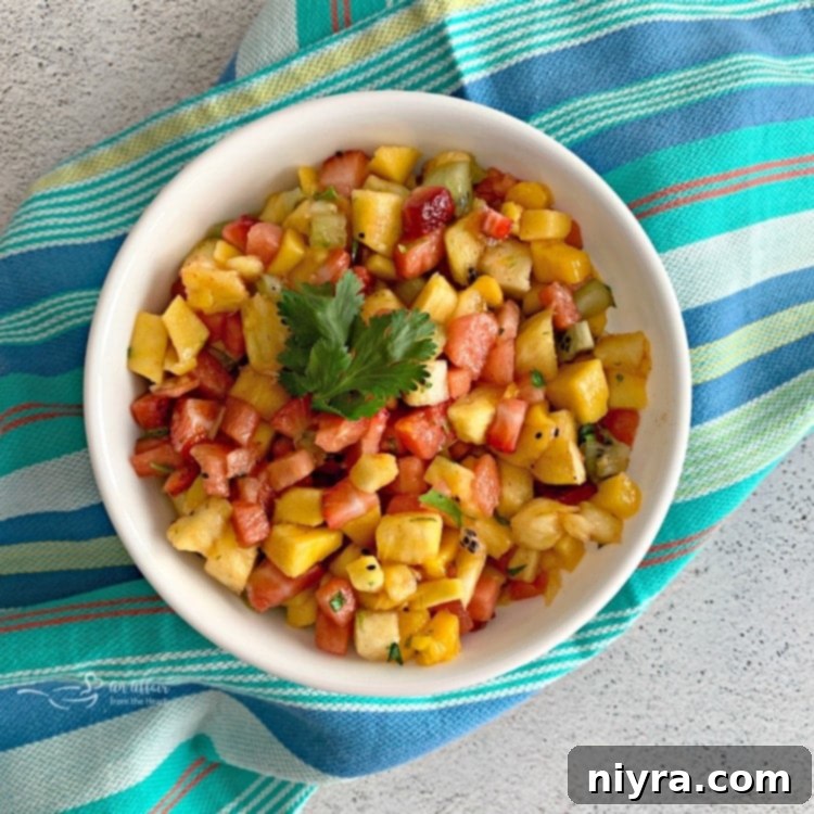 Finished Tropical Salsa in a mixing bowl, showcasing the colorful diced fruits ready to be served with nachos.