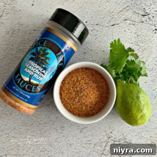 Spice Isle Tropical Seasoning Rub jar, showing the coarse texture of the spice blend, perfect for marinating chicken.