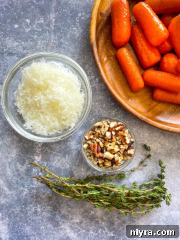 Close-up of orange glazed carrots in a pan, with the thick, glistening sauce coating them perfectly.