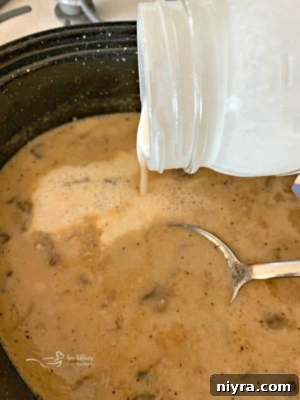 Gravy from the Fuggedaboutit Pork Roast being prepared in a pan on the stove, showing its rich texture.