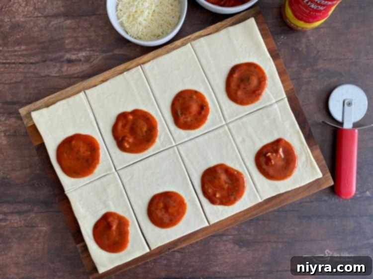 Dorothy's Pizza Pockets Prep - Adding sauce to puff pastry.
