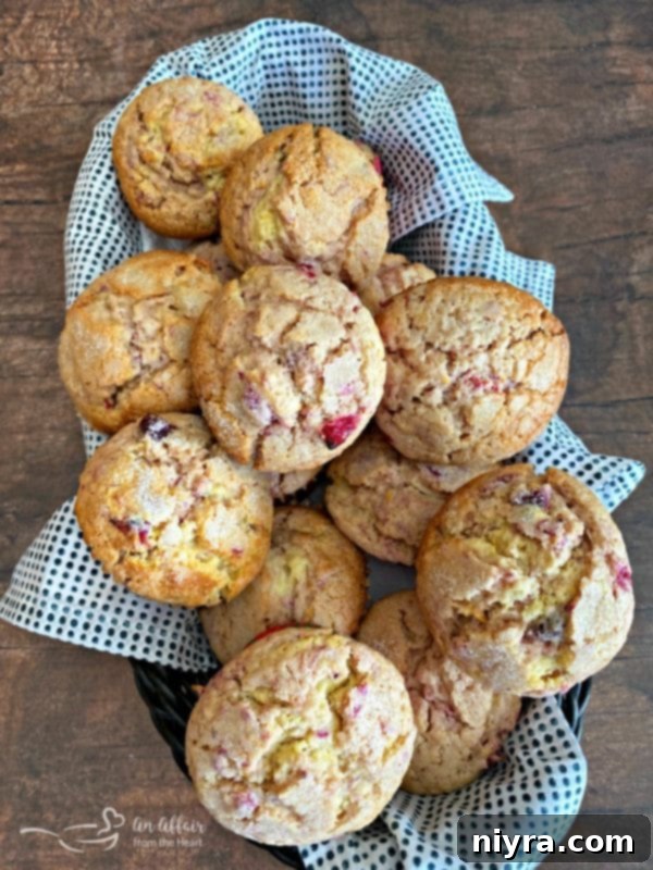 Freshly baked Cranberry Orange Muffins cooling gracefully on a wire rack