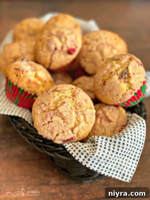 Basket filled with warm, freshly baked Cranberry Orange Muffins, ready to be enjoyed