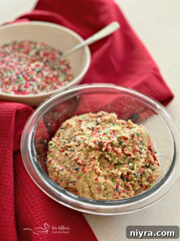 Cookie dough rolled in sprinkles, ready for baking