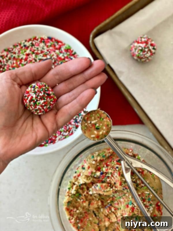 Unbaked Funfetti Sugar Cookie dough balls on a baking sheet