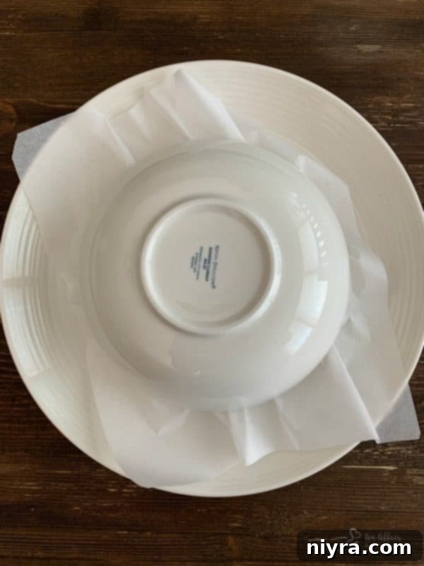 Hot Melted Parmesan Cheese being flipped over a bowl for shaping