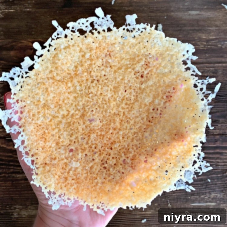 Finished Parmesan Cheese Bowl held in hand, showcasing its edible design