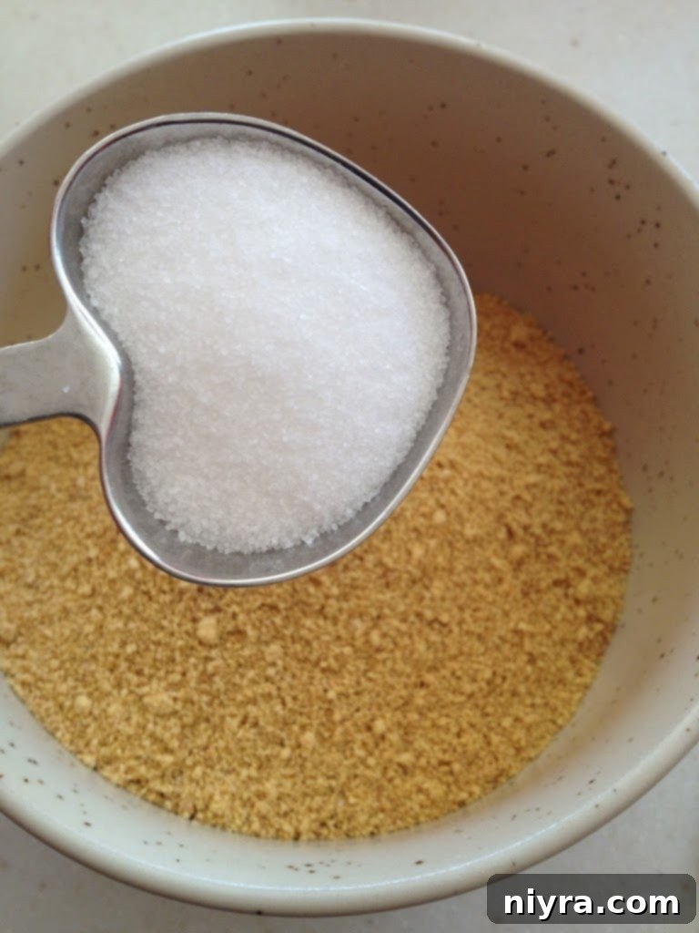 Close-up of a single lemon raspberry cheesecake, showcasing its creamy texture and fresh raspberry topping in a glass container.