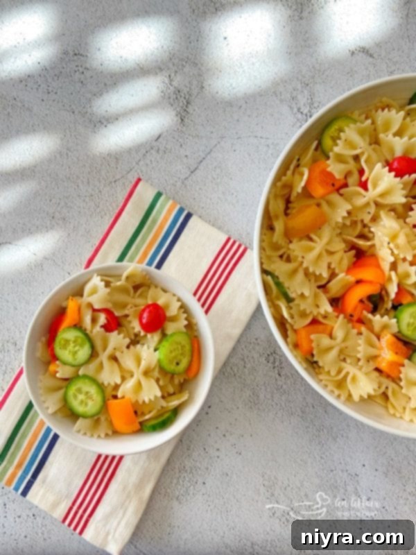 Easy French Vinaigrette Pasta Salad served in two bowls, one large and one small