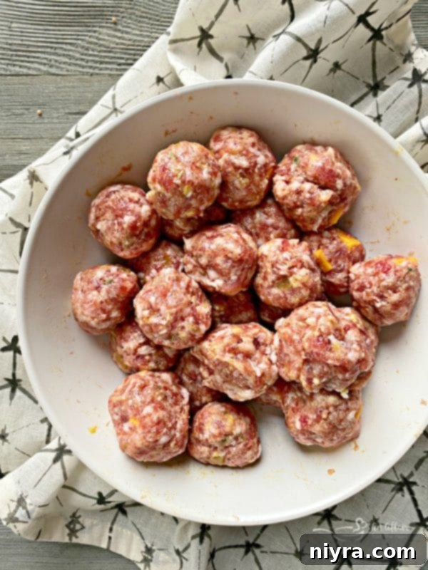Sausage Pretzel Bombs with Tangy Cheese Dip 10 Sausage Stuffed Pretzel Bombs prep: Portioning meatballs with a scoop