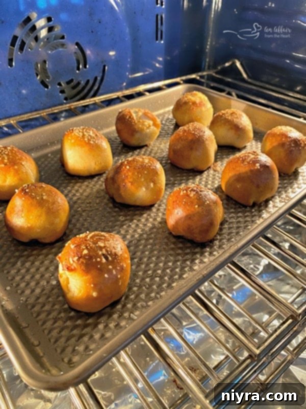 Sausage Pretzel Bombs with Tangy Cheese Dip 14 Sausage Pretzel Bombs baking in the oven