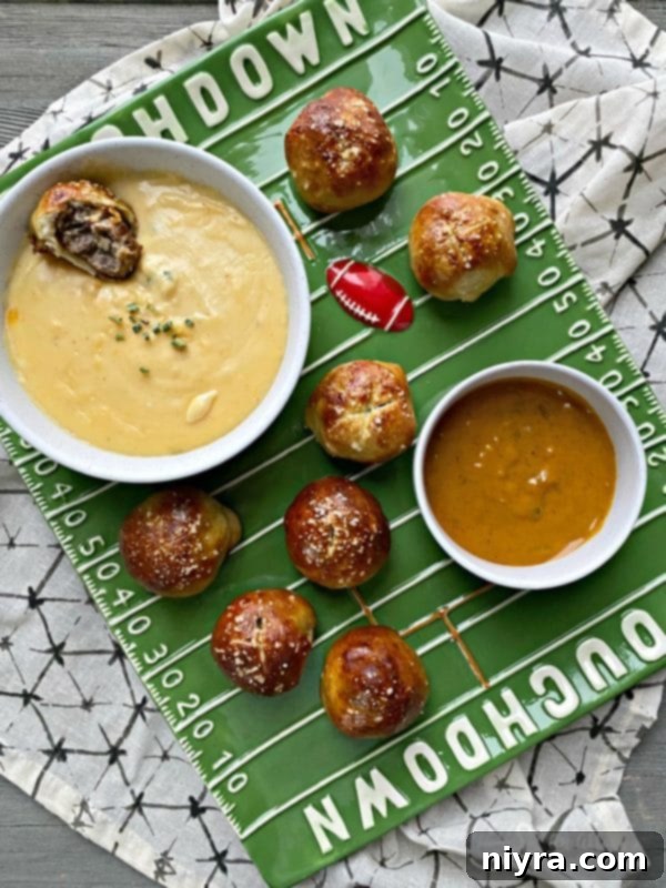Sausage Pretzel Bombs with Tangy Cheese Dip 5 Sausage Pretzel Bombs served on a football-themed plate