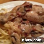 Close up of Country Club Chicken on a white plate with text "Country Club Chicken"