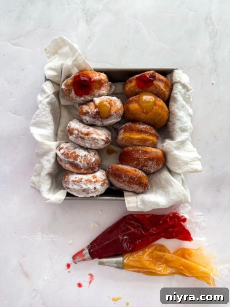 Pączki: The Ultimate Polish Donuts Video 13 Freshly fried Paczki draining on paper towels, golden and perfectly puffed.
