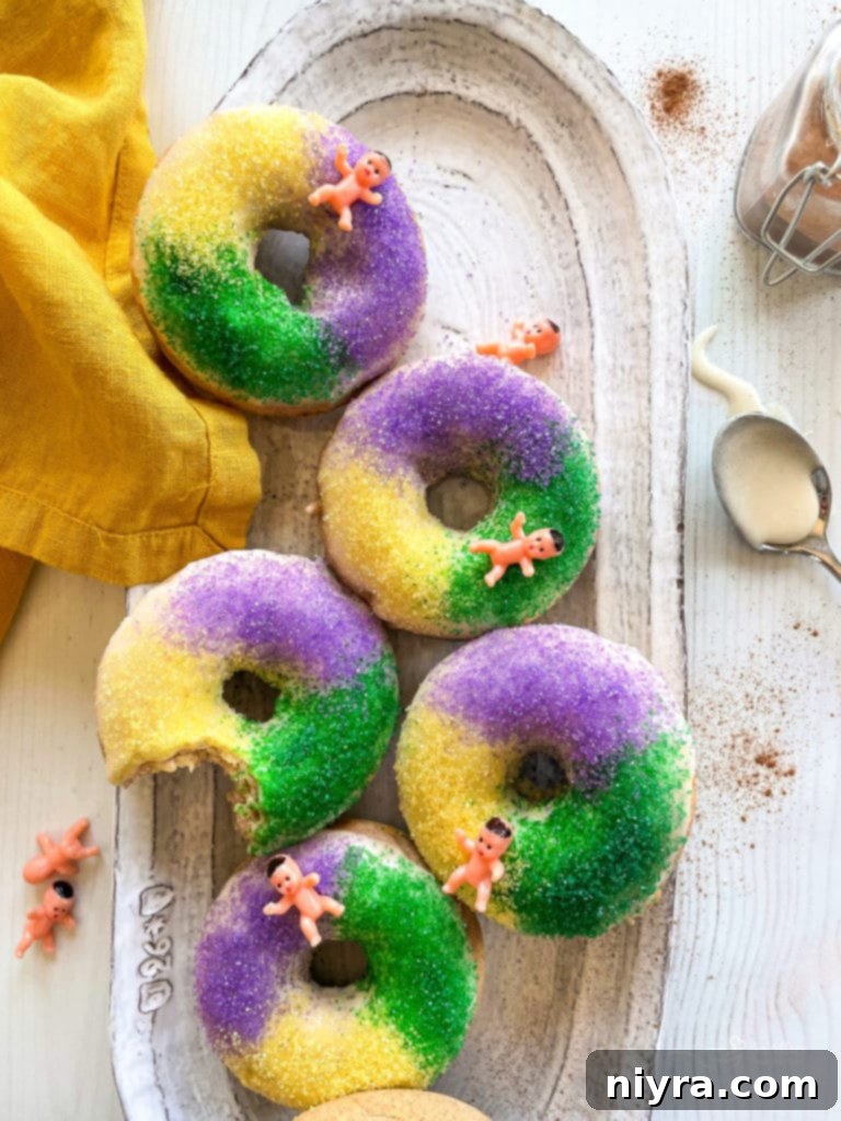 Pączki: The Ultimate Polish Donuts Video 16 King Cake Baked Donuts arranged on a platter with a gold napkin, showcasing another festive Fat Tuesday treat.