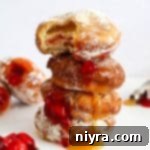 Pączki: The Ultimate Polish Donuts Video 20 4 Pączki (Polish Donuts) stacked with the filling dripping out.