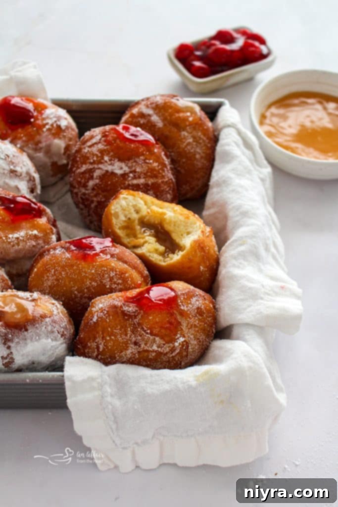 Pączki: The Ultimate Polish Donuts Video 3 Close-up of freshly fried Paczki, showing their soft, pillowy texture and golden hue, ready for filling.