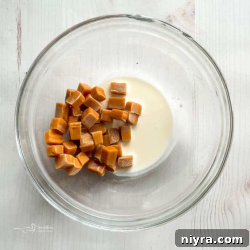 Marshmallows and mini peanut butter cups sprinkled over Chex Mix