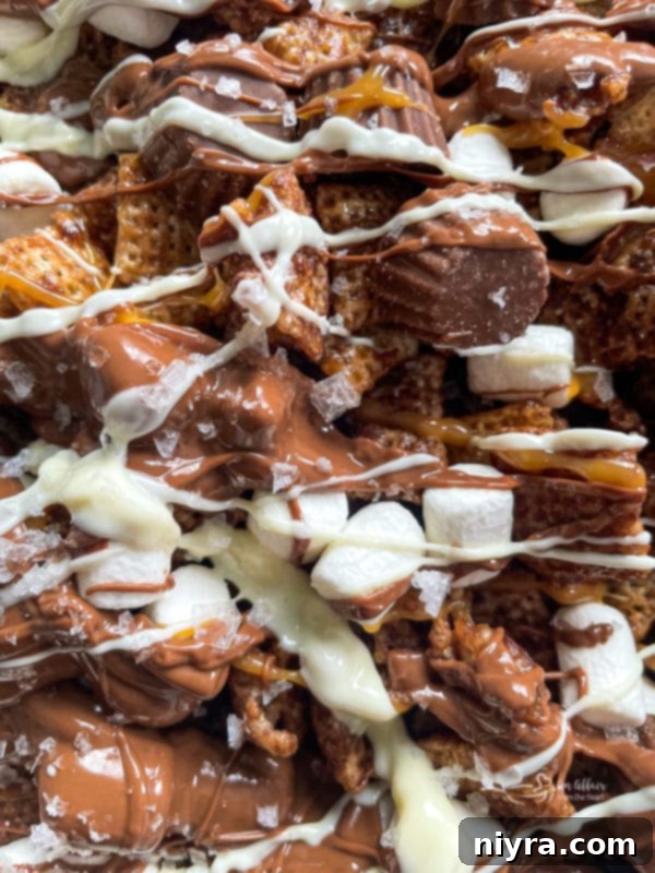 Milk and white chocolate being drizzled over the Chex Mix