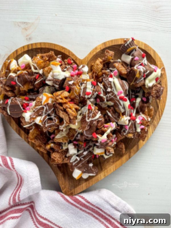 Close-up of chocolate-coated Chex Mix with mini peanut butter cups and marshmallows
