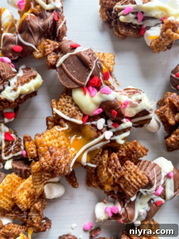 Plate of chocolate Chex Mix with mini peanut butter cups and marshmallows