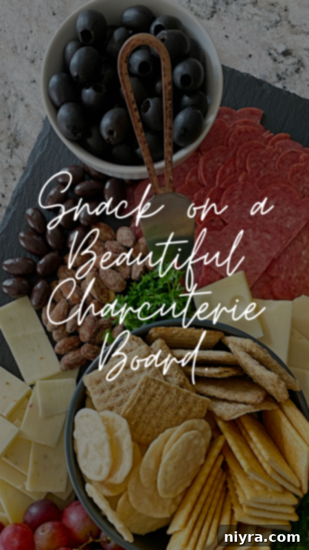 Gourmet charcuterie board with artisanal cheeses, cured meats, and fresh fruits