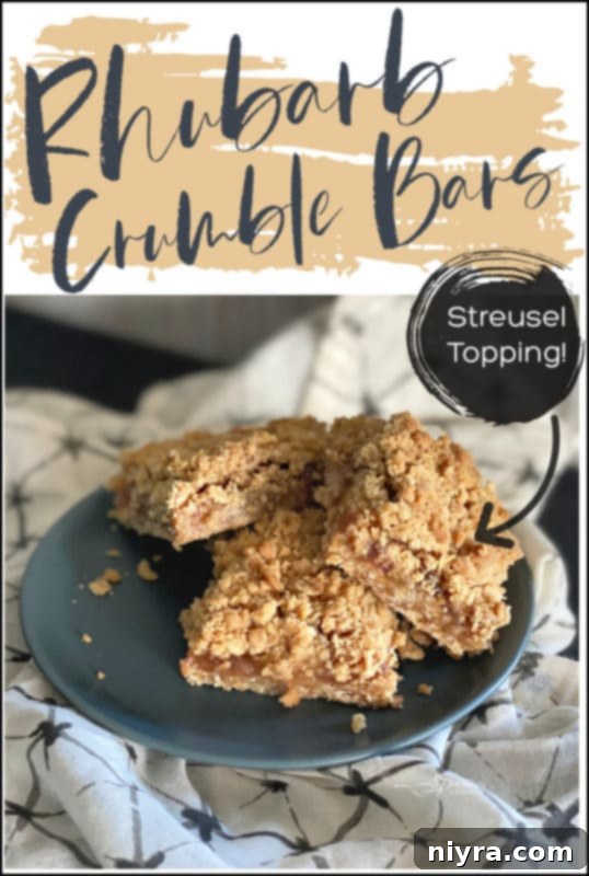 Stacked Rhubarb Crumble Bars on a white plate