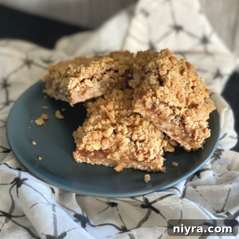 Overhead view of cut Rhubarb Crumble Bars with a fork