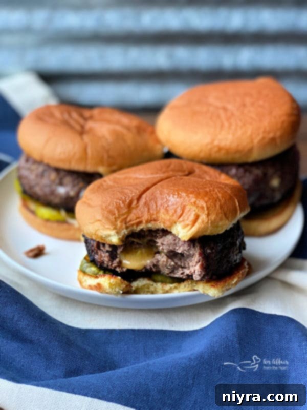 Another perspective of a Juicy Lucy burger on a plate, ready to be enjoyed.