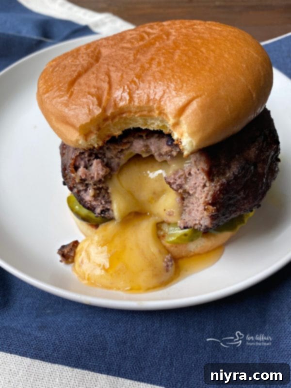 A grilled Juicy Lucy burger, ready to be served, highlighting its appealing crust.