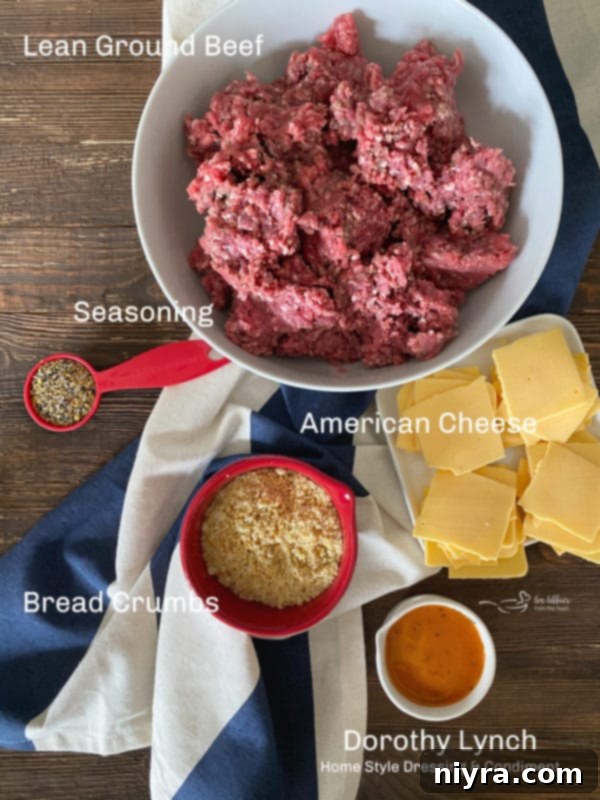 Ingredients for Juicy Lucy burgers laid out on a wooden cutting board, including ground beef, seasoning, breadcrumbs, and Dorothy Lynch dressing.