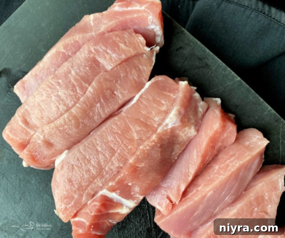 Cooked pork chops wrapped in bacon, showing a glazed and crispy texture, prepared as an alternative to ribs.