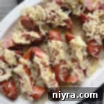 Top view of Grilled Polish Sausage and Sauerkraut white platter