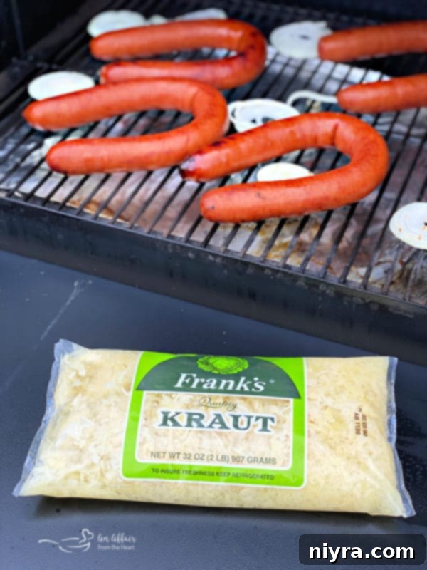 Ingredients for grilled Polish sausage and sauerkraut: sausages, onion, apple juice, Frank's Kraut, Dijon mustard, and spices