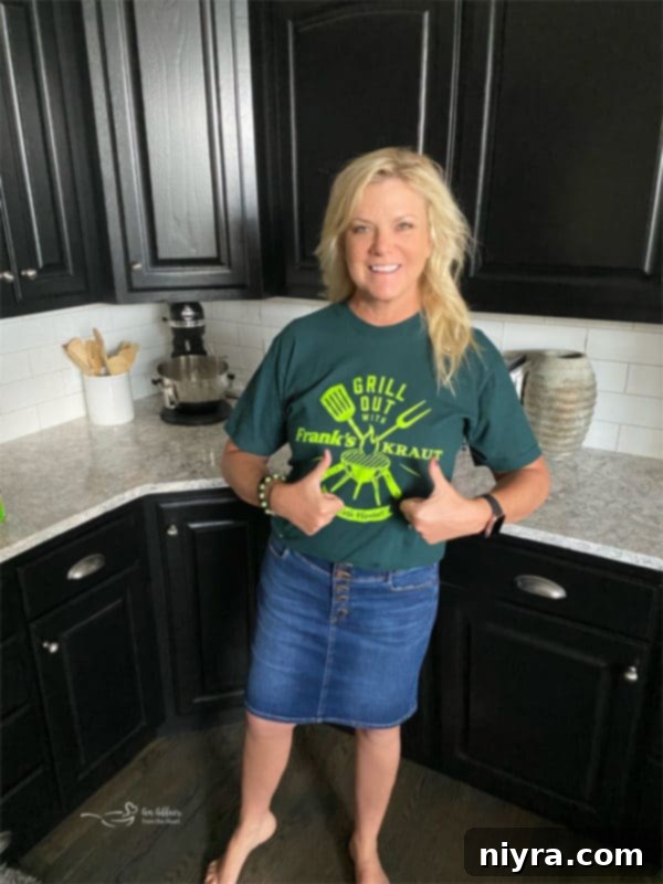 Woman wearing a 'Grill Out With Frank's Kraut' t-shirt