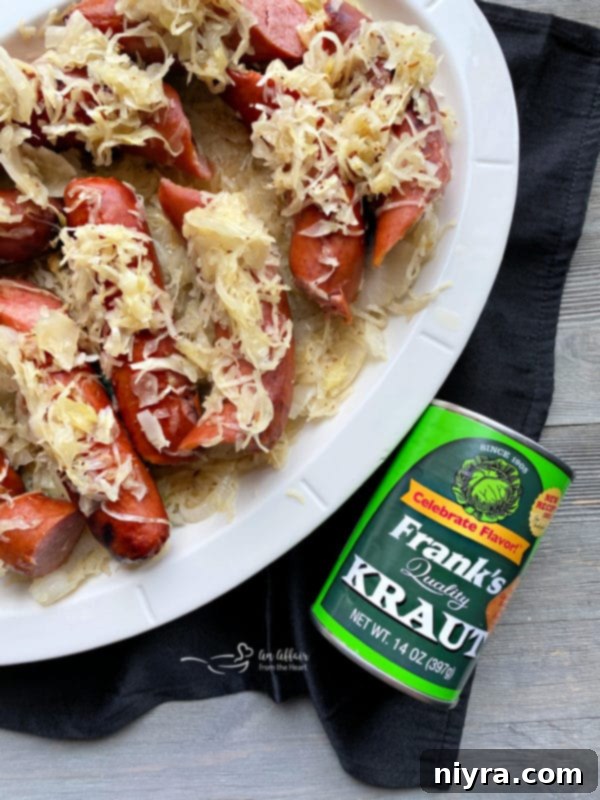 Plate of grilled Polish sausage and sauerkraut served on hard rolls, garnished with fresh parsley