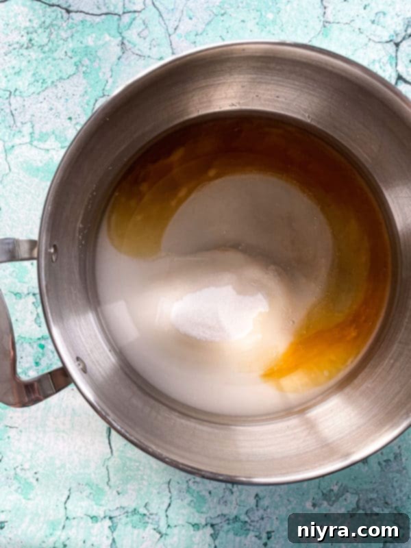 Pan with corn syrup and sugar for making peanut brittle candy