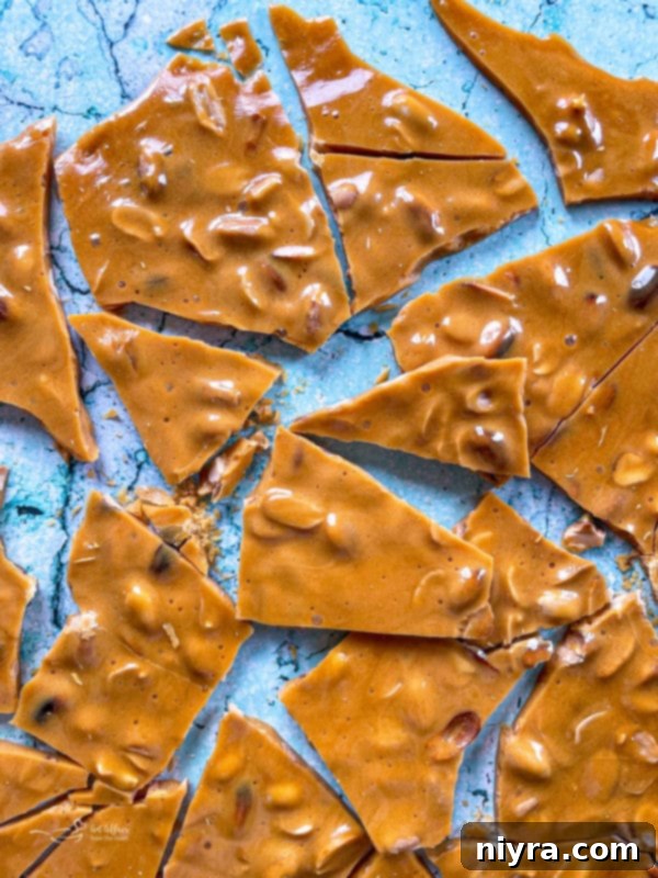 Peanut brittle cooling and cracked on a marble surface