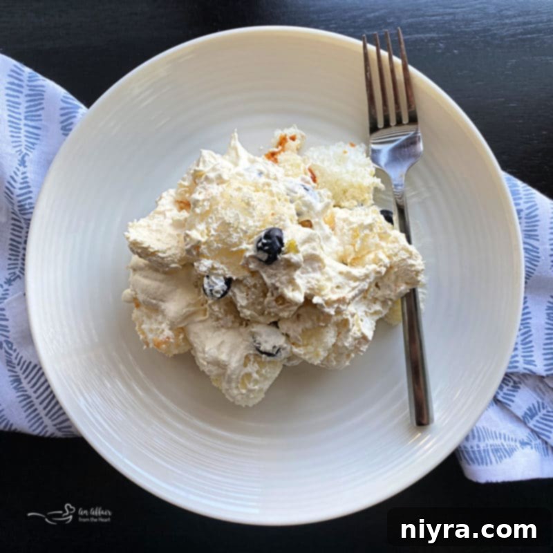 Bright Lemon Blueberry Trifle 7 Lemon Blueberry Trifle served on a plate with a spoon