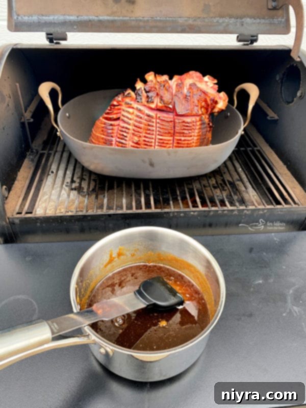 Glazing a smoked ham on the traeger