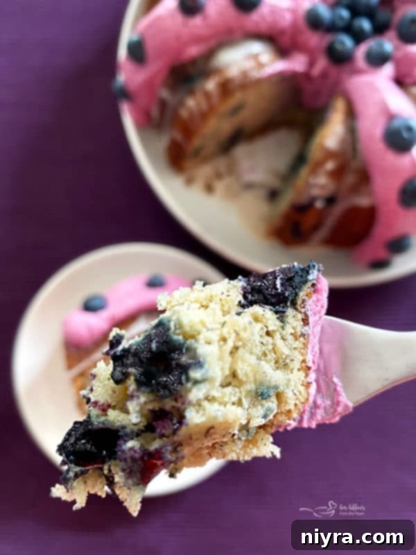 A beautifully sliced Blueberry Banana Bundt Cake, revealing the moist interior