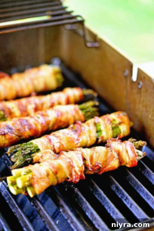 Grilled asparagus bundles, elegantly wrapped in crispy bacon.