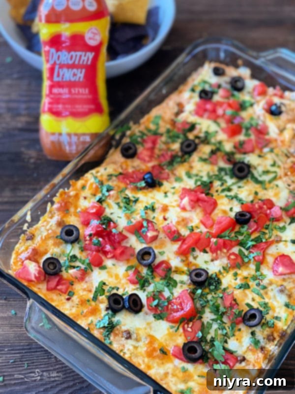 Hot Taco Dip baking in the oven, with a golden-brown cheesy crust