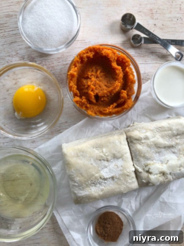Ingredients for pumpkin pie turnovers laid out on a table