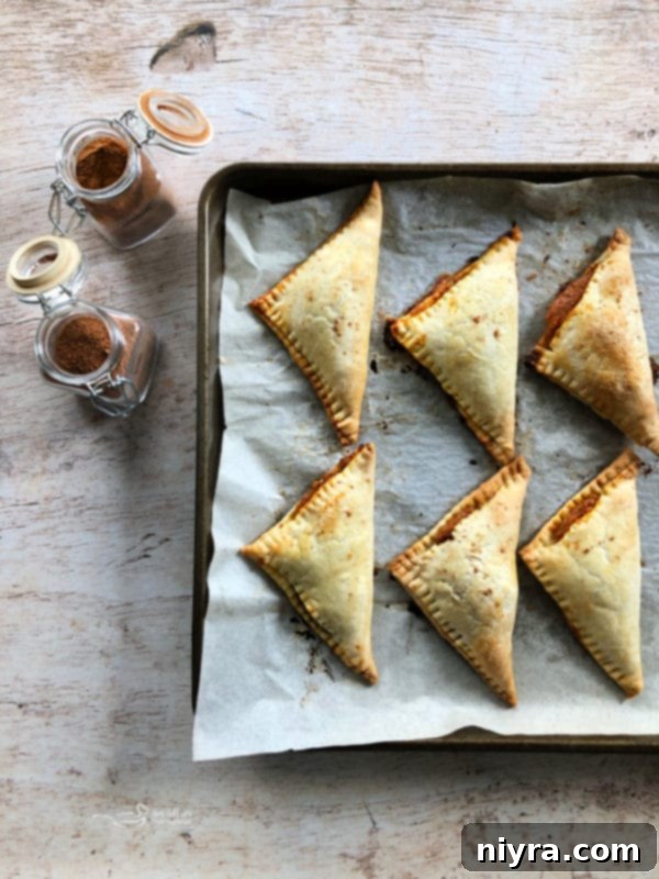 Close-up of a pumpkin pie turnover with glaze dripping