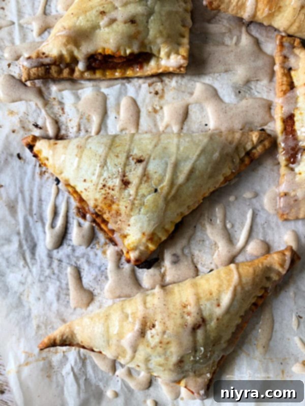 Stacked pumpkin pie turnovers on a plate