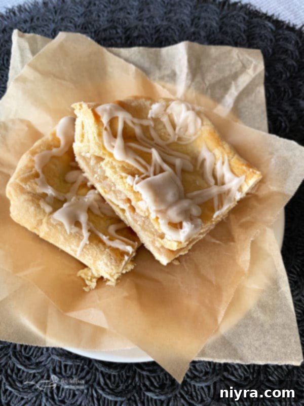 Warm Apple Bars with flaky crust and sweet glaze on a rustic wooden surface, ready to be served